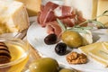 Food composition of pieces of moldy cheese, prosciutto, olives, Royalty Free Stock Photo