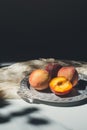 food composition with ripe peaches on metal tray on marble tabletop Royalty Free Stock Photo