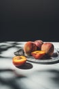 food composition with ripe peaches on metal tray on marble tabletop Royalty Free Stock Photo