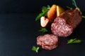 Food concept dried cured sausage on black slate board with copy space Royalty Free Stock Photo