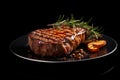 Grilled meat steak on plate in black background with copy space Royalty Free Stock Photo