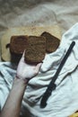 Food concept. Hand cutting bread. Slicing a bread. Top view