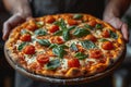 Food concept. A happy professional chef presents freshly prepared pizza from the oven Royalty Free Stock Photo