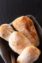 Food concept homemade artisan classic Italian style yeast dough Ciabatta bread on black slate board with copy space