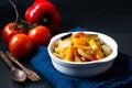 Food concept Homemade French organic Ratatouille in white bake ceramic bowl on blask slate stone board Royalty Free Stock Photo