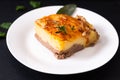 Food concept homemade organic Mashed Potato Beef Casserole on white ceramic plate on black slate stone background Royalty Free Stock Photo