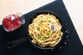 Food concept homemade spaghetti creamy white sauce in cast-iron skillet pan on slate stone
