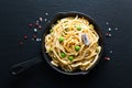 Food concept homemade spaghetti creamy white sauce in cast-iron skillet pan on slate stone Royalty Free Stock Photo