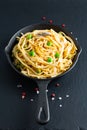 Food concept homemade spaghetti creamy white sauce in cast-iron skillet pan on slate stone Royalty Free Stock Photo