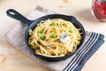 Food concept homemade spaghetti creamy white sauce in cast-iron skillet pan on wood Royalty Free Stock Photo