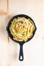 Food concept homemade spaghetti creamy white sauce in cast-iron skillet pan on wood Royalty Free Stock Photo