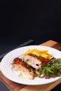 Food concept Homemade Veal cordon bleu with salad and french fried in white ceramic plate on wooden board and black slate stone Royalty Free Stock Photo