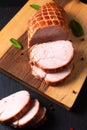 Food concept organic turkey or chicken cured ham German Kassler or Kasseler on wooden board with copy space