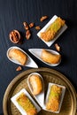 Food concept Oriental arab dessert baklava walnuts and rolled Kanafeh on black slate board with copy space Royalty Free Stock Photo