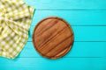 Food concept. Pizza cutting board, green plaid tablecloth on blue wooden background. Top view. place for text. Copy space. Mock up Royalty Free Stock Photo