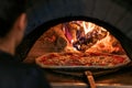 Food concept. Preparing traditional italian pizza. Baked pizza in the front of the oven Royalty Free Stock Photo