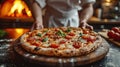 Food concept. Preparing traditional italian pizza. Young smiling chef in uniform Royalty Free Stock Photo