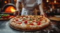 Food concept. Preparing traditional italian pizza. Young smiling chef in uniform Royalty Free Stock Photo