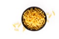 Food concept raw organic Italian Fusili pasta in black bowl isolates on white with copy space