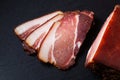 Food concept spot focus Artisan Fresh smoked Bacon on slate stone board with copy space