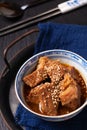 Food concept spot focus Homemade Korean Beef Stew in oriental style porcelain cup on black background with copy space