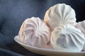 Food, confection and sweets concept - close up of zephyr or marshmallow dessert on plate Royalty Free Stock Photo