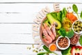 Food containing natural vitamin E: Spinach, parsley, shrimp, pumpkin seeds, eggs, avocados, broccoli. Top view.
