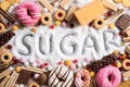 Food containing sugar. mix of sweet donuts, cakes and candy with sugar spread and written text in unhealthy nutrition, chocolate Royalty Free Stock Photo