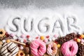 Food containing sugar. mix of sweet donuts, cakes and candy with sugar spread and written text in unhealthy nutrition, chocolate Royalty Free Stock Photo