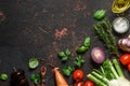 Food cooking background on black stone table. Fresh vegetables, spices, herbs and oil. Top view Royalty Free Stock Photo