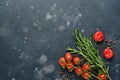 Food cooking background. Fresh rosemary, cilantro, basil, cherry tomatoes, peppers and olive oil, spices herbs and vegetables at Royalty Free Stock Photo