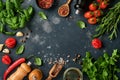 Food cooking background. Fresh rosemary, cilantro, basil, cherry tomatoes, peppers and olive oil, spices herbs and vegetables at Royalty Free Stock Photo