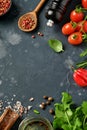 Food cooking background. Fresh rosemary, cilantro, basil, cherry tomatoes, peppers and olive oil, spices herbs and vegetables at Royalty Free Stock Photo