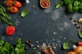 Food cooking background. Fresh rosemary, cilantro, basil, cherry tomatoes, peppers and olive oil, spices herbs and vegetables at Royalty Free Stock Photo