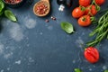 Food cooking background. Fresh rosemary, cilantro, basil, cherry tomatoes, peppers and olive oil, spices herbs and vegetables at b Royalty Free Stock Photo