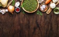 Food cooking background. Ingredients for prepare green lentils with vegetables, spices and herbs, wooden kitchen table background