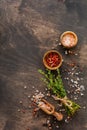 Food cooking background. Spices herbs bunch thyme and seasoning salt and pepper at black slate table. Food ingredients top view Royalty Free Stock Photo