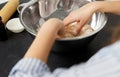 Close up of hands kneading dough at bakery