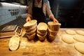 Baker with baskets for bread dough at bakery Royalty Free Stock Photo