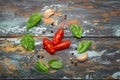 Food cooking border with cherry tomatoes, fresh green basil and garlic cloves top view on rustic colourful wooden