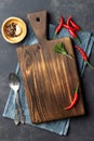 Food cooking concept. Vintage wooden kitchen board, cutlery and red pepper over napkin Royalty Free Stock Photo