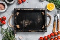 Food cooking and healthy eating background with wooden cutting board and fresh seasoning, herbs and vegetables. Gray Royalty Free Stock Photo