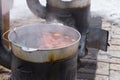 Food cooking on an outdoor wood burner stove