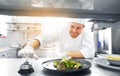 Happy male chef cooking food at restaurant kitchen Royalty Free Stock Photo