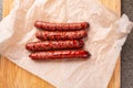 Food, delicious and serving concept - grilled sausages on wooden board Royalty Free Stock Photo