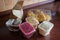 Food delivery from the cafe: A paper bag with pastries and plastic containers with Russian salad, beetroot salad, squid and