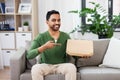 Indian man with box of takeaway pizza at home Royalty Free Stock Photo