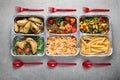 Food delivery containers with different meals on light table, top view Royalty Free Stock Photo