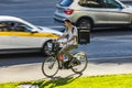 food delivery courier delivering food on bicycle. Cyclist carrying backpack with food and drinks. Fast delivery within the city