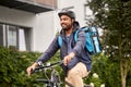 food delivery man with bag riding bicycle Royalty Free Stock Photo